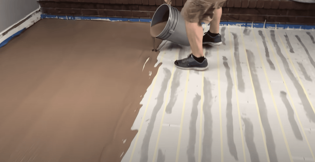 The first person pours the texture coat out of a bucket.