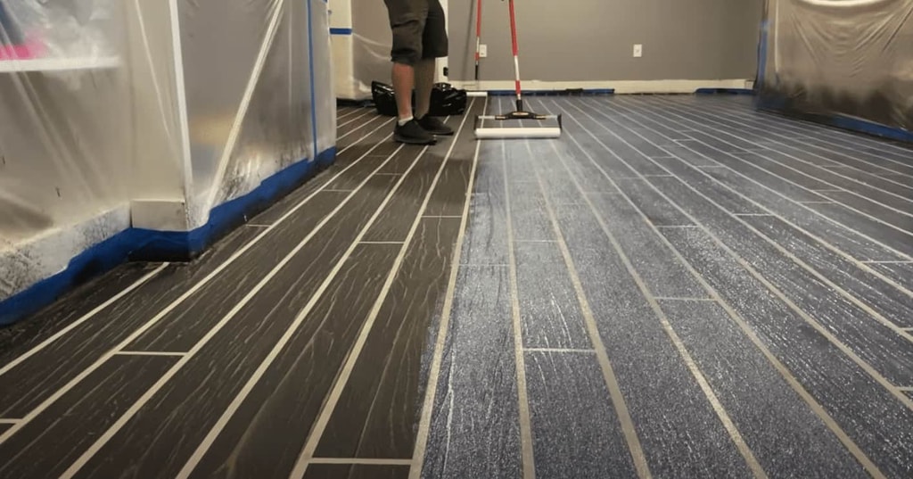 We apply the urethane gloss coat with a paint roller to completely seal the floor.