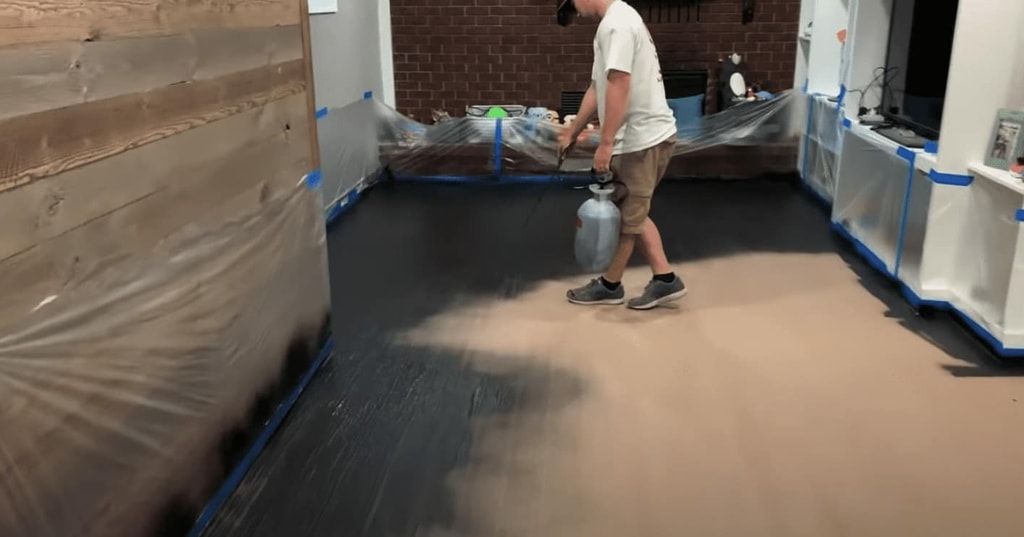 Once our texture coat is dry, we evenly spray out the stain across the entire floor.