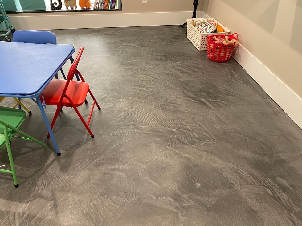 A simple, yet durable gray epoxy floor installed in a children's play area.  This floor features a matte urethane topcoat for extra durability.