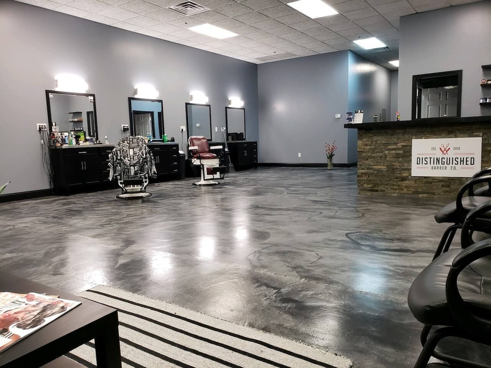 Barbershop with eye-catching epoxy floors.  This floor uses a gray base with black highlights - making the space look professional and mordern.