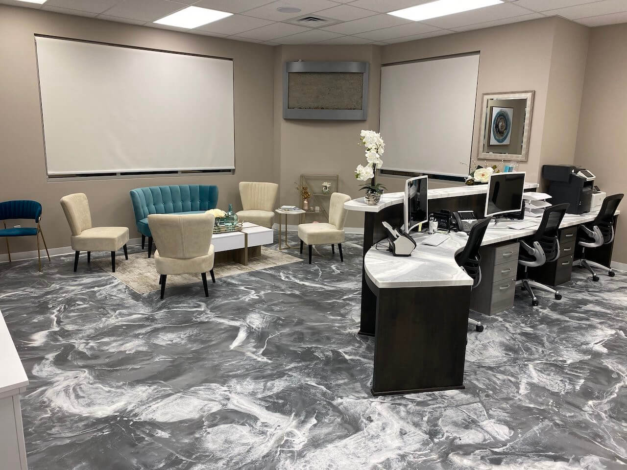 A white and gray epoxy floor installed in a modern office reception area. 
