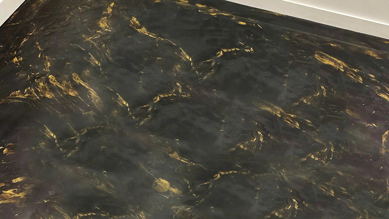 Here we feature metallic epoxy garage floor colors in black and gold.