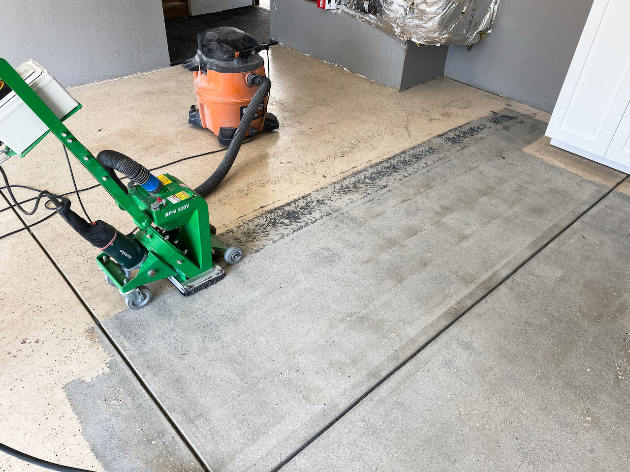 Shot blasting a concrete floor to remove the top layer of the aggregate.