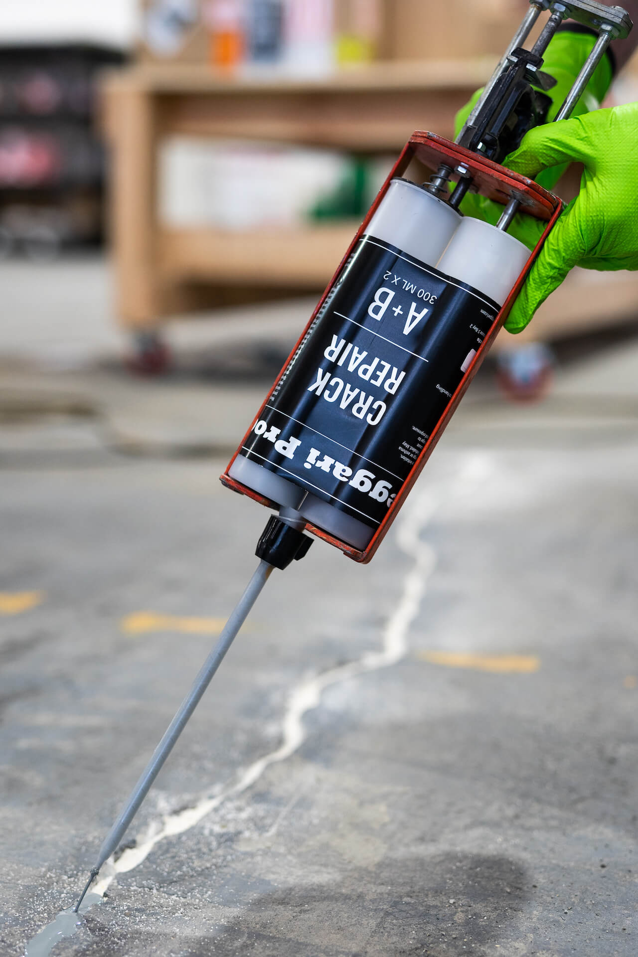Applying Leggari's two-part crack repair product to a badly cracked concrete floor.