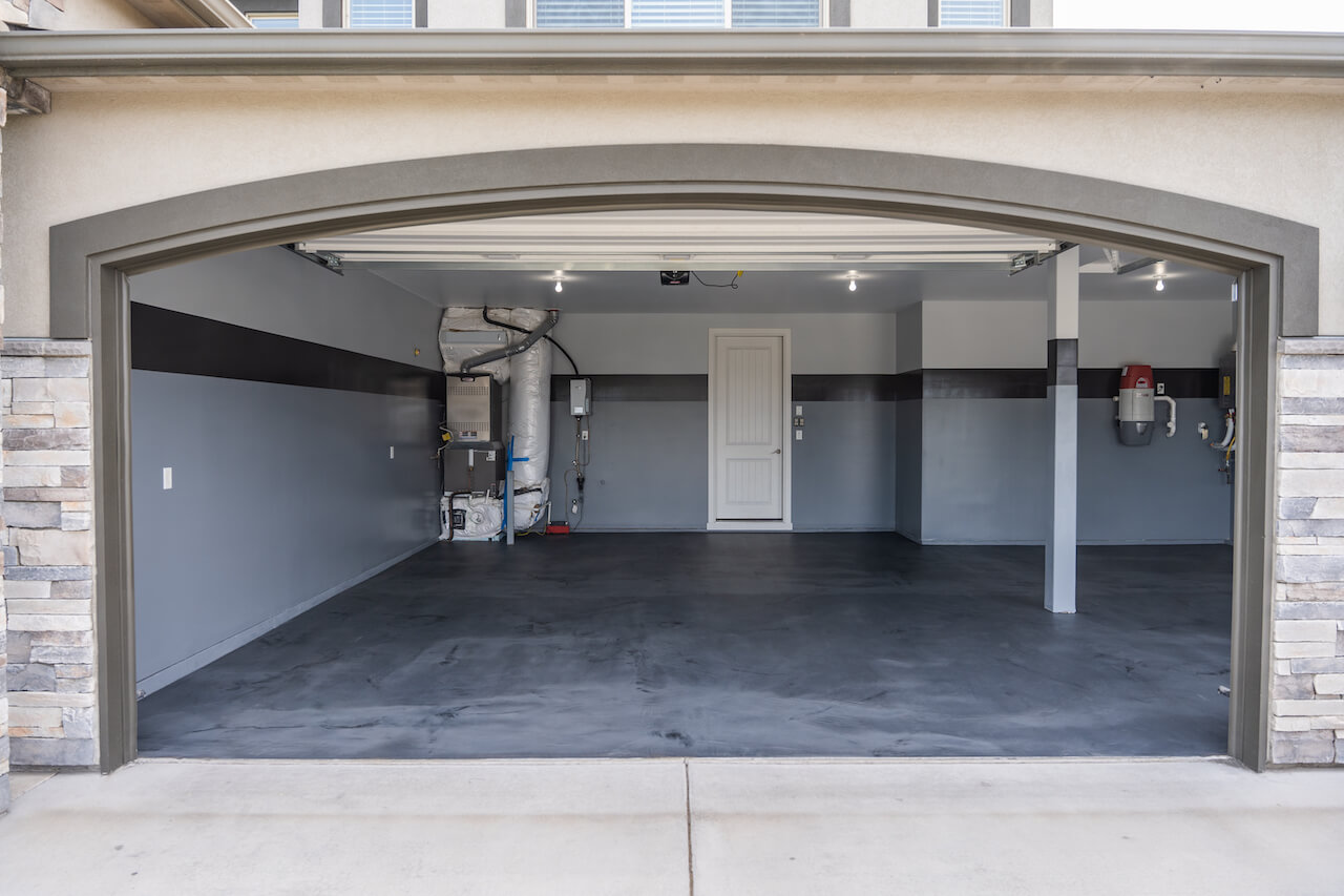 The garage of this modern home has been coated with gray and black metallic epoxy creating a multi-layered look.